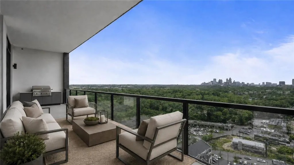 Large Terrace off Kitchen with built-in grill and double glass doors open to living and kitchen space.