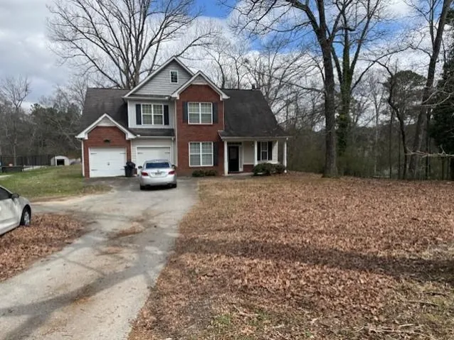 View of front of property with driveway and a porch