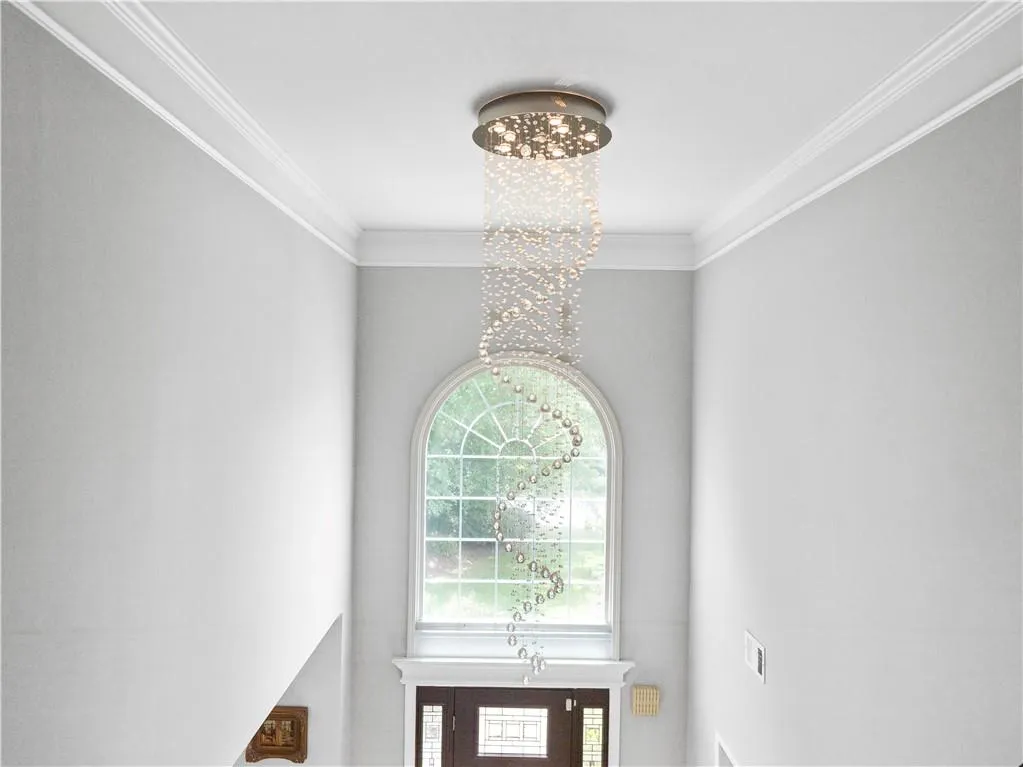 Interior details featuring an inviting chandelier and crown molding