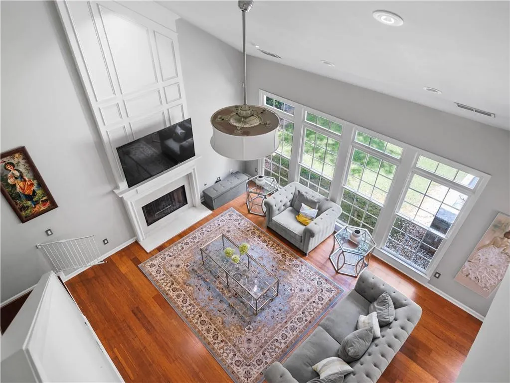 Living room with wood-type flooring and high vaulted ceiling