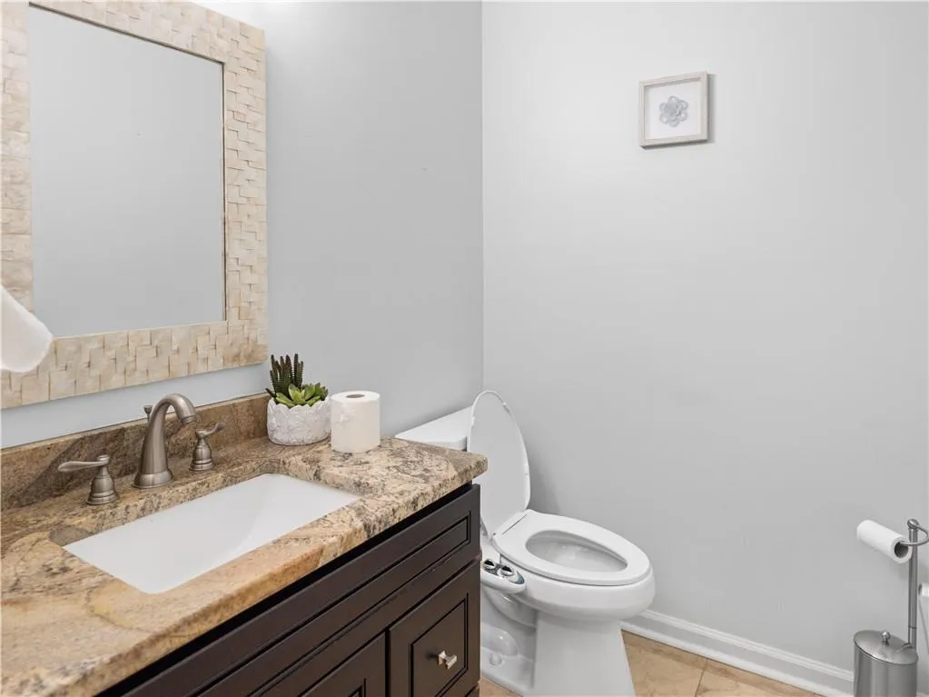 Bathroom with vanity, tile patterned flooring, and toilet