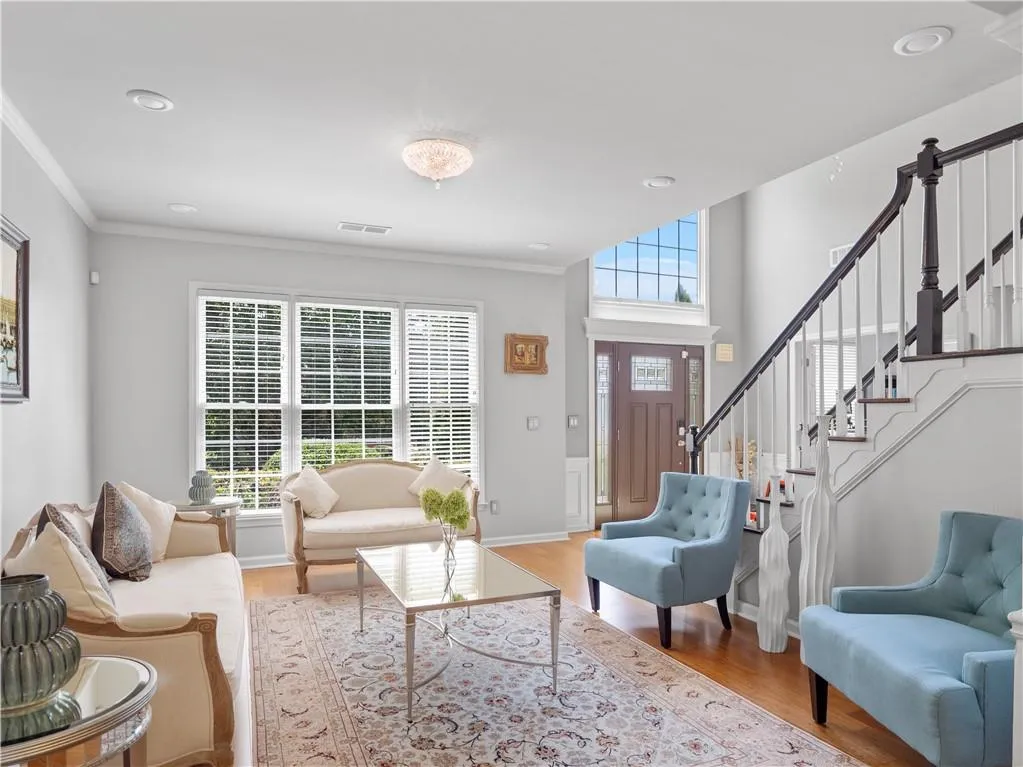 Living room featuring ornamental molding and hardwood / wood-style floors