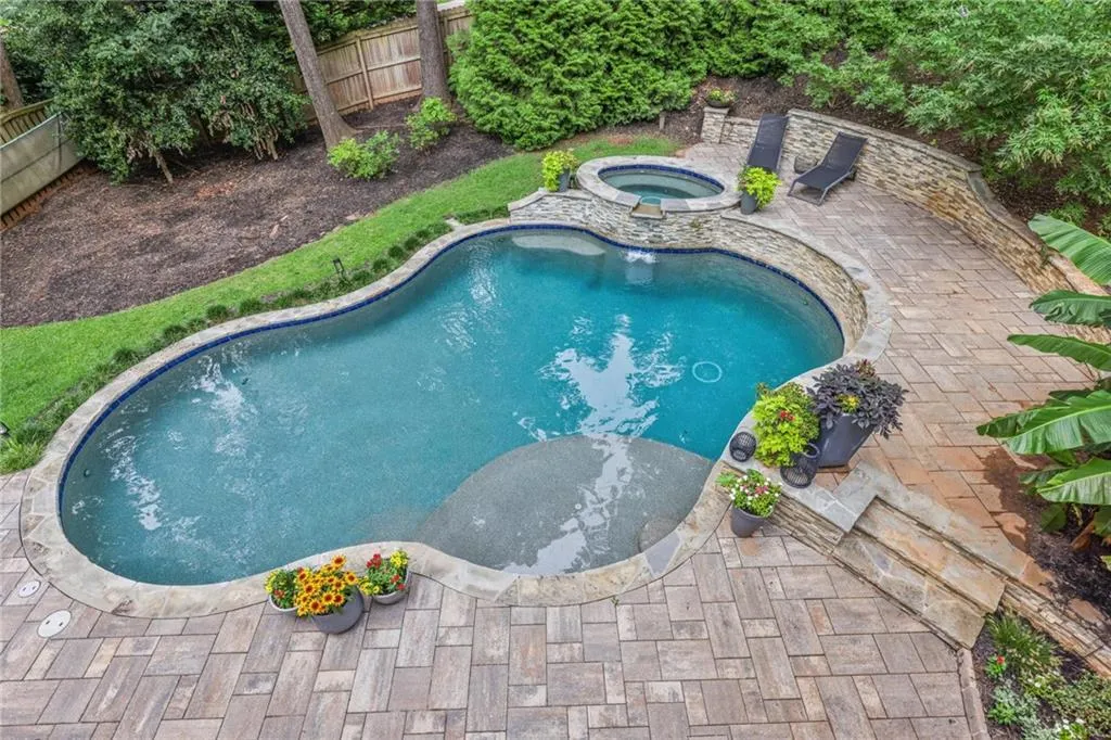 View of swimming pool featuring an in ground hot tub and a patio