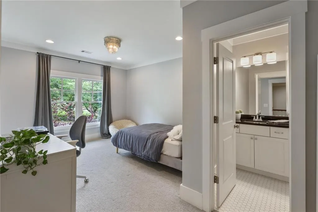 Carpeted bedroom featuring sink