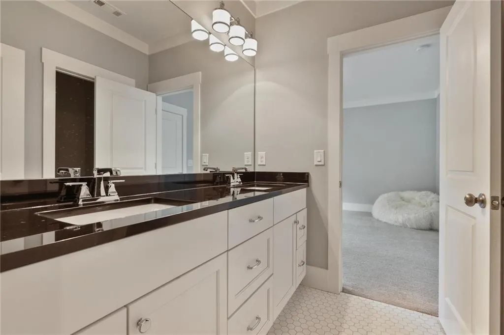 Bathroom with dual vanity and tile patterned floors