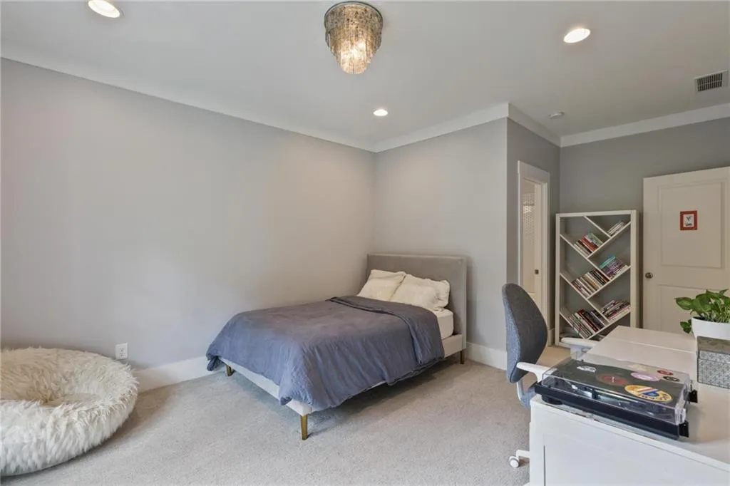 Bedroom featuring carpet floors and crown molding