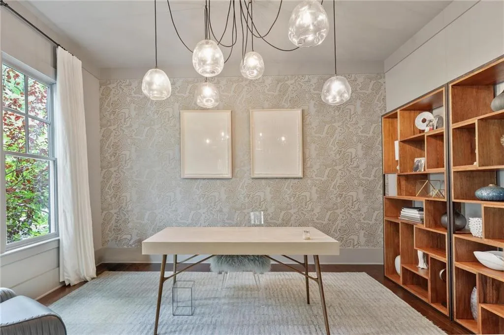Office with a healthy amount of sunlight and hardwood / wood-style flooring