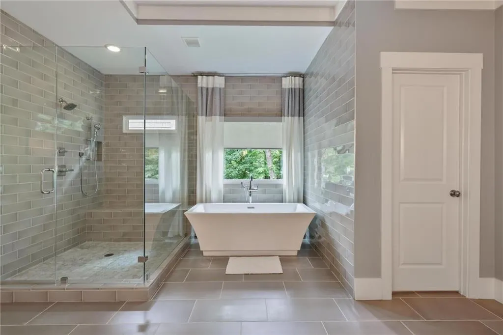 Bathroom featuring independent shower and bath and tile patterned floors