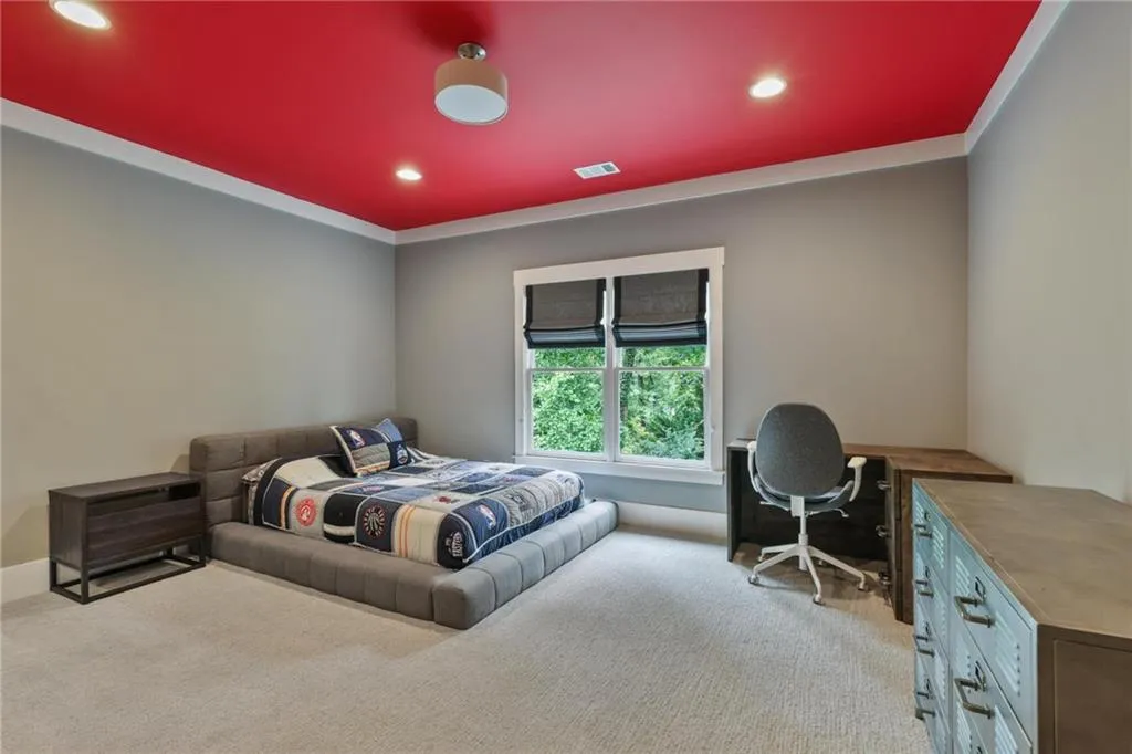 Carpeted bedroom with ornamental molding
