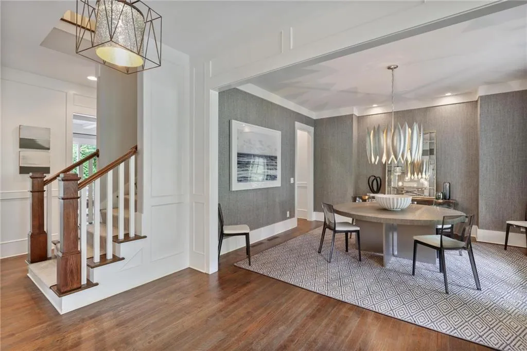 Dining room with hardwood / wood-style flooring and a notable chandelier