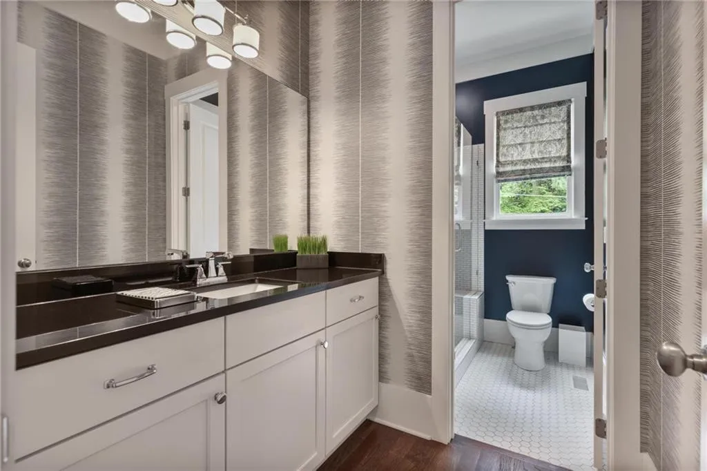 Bathroom with tile patterned floors, toilet, and vanity