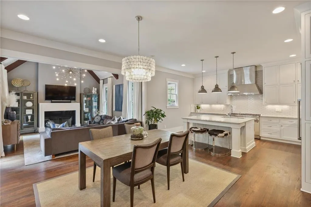 Dining space featuring vaulted ceiling, hardwood / wood-style floors, and a chandelier