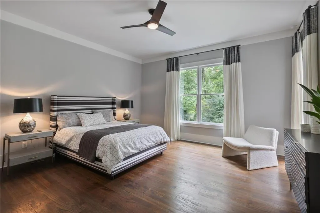 Bedroom featuring crown molding, ceiling fan, and wood-type flooring