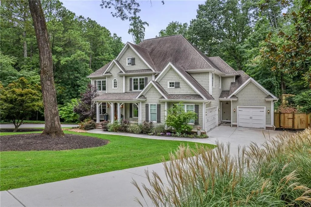 Craftsman house with a garage and a front lawn