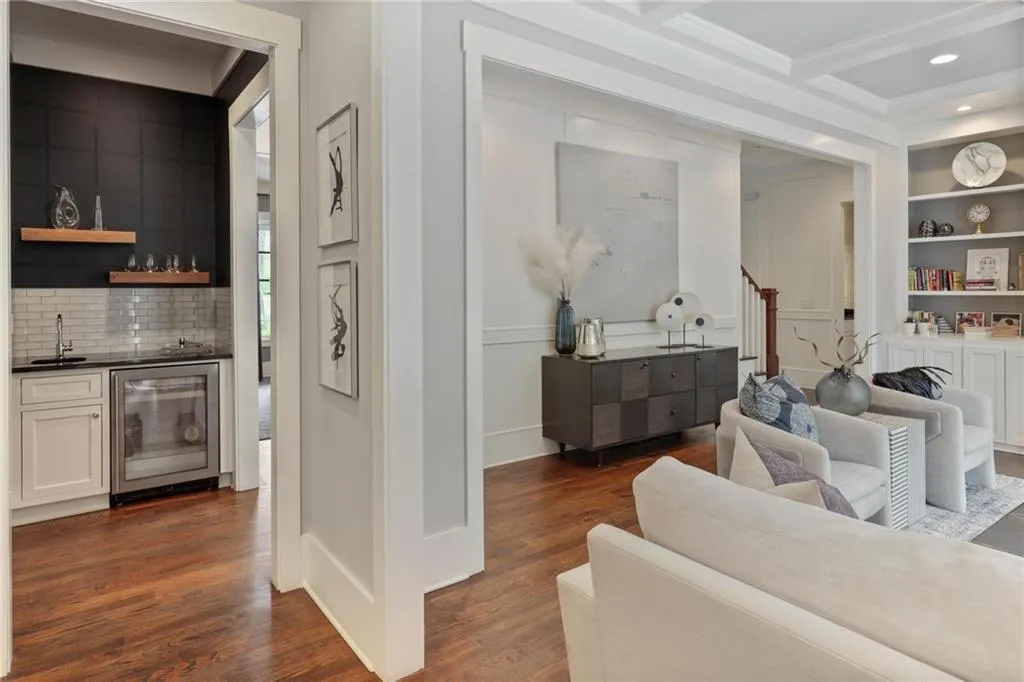 Living room featuring built in features, dark hardwood / wood-style floors, beverage cooler, and coffered ceiling