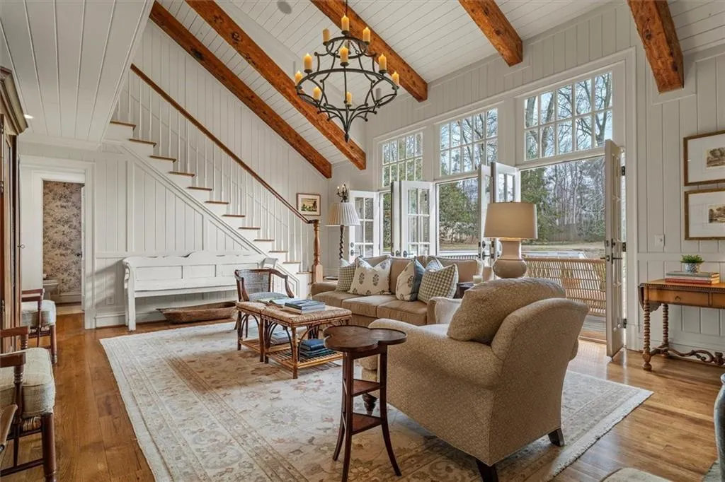 Beamed vaulted ceiling in the Family room opens to back deck through triple French doors