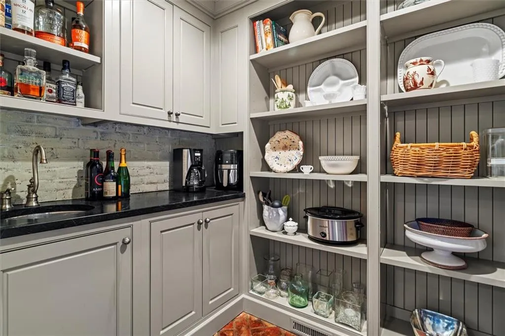 Custom wood shelved walk-in pantry with wet bar
