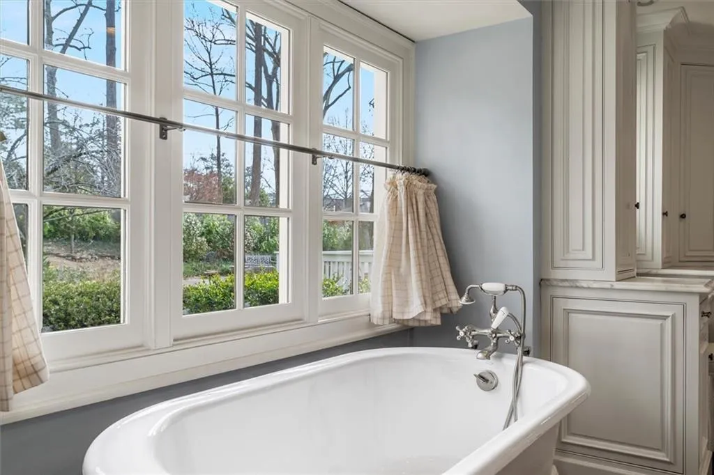 Primary bath soaking tib overlooks private back yard