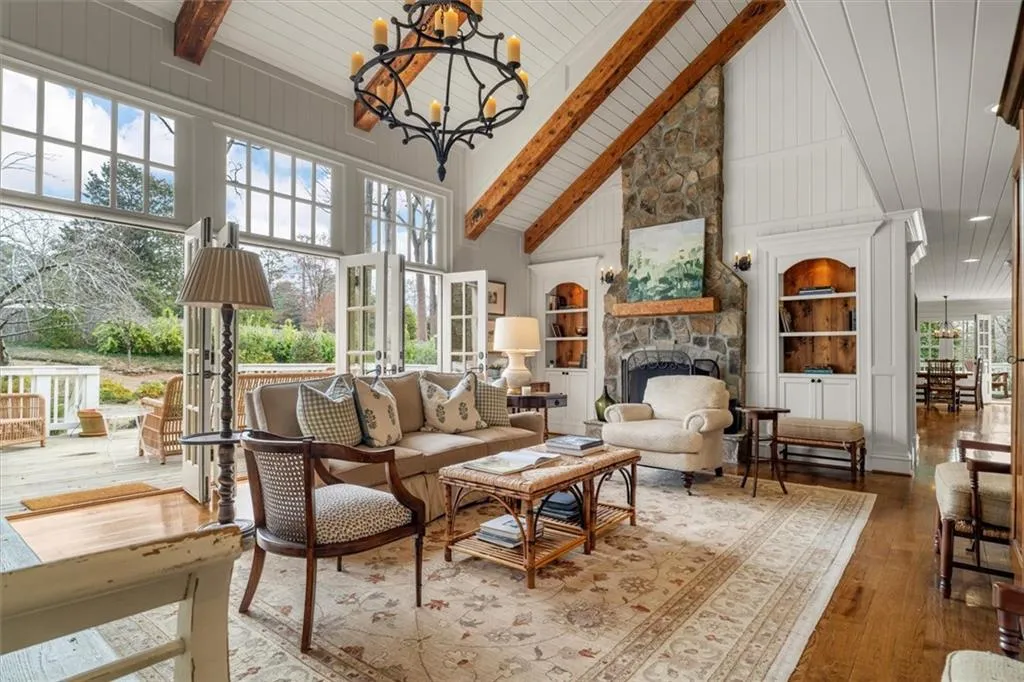Family room has stack stone fireplace & built-in cabinetry