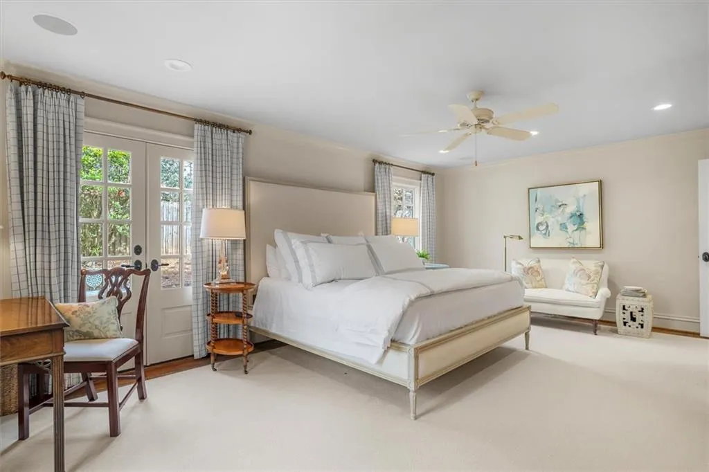 Primary suite opens to private patio through French doors