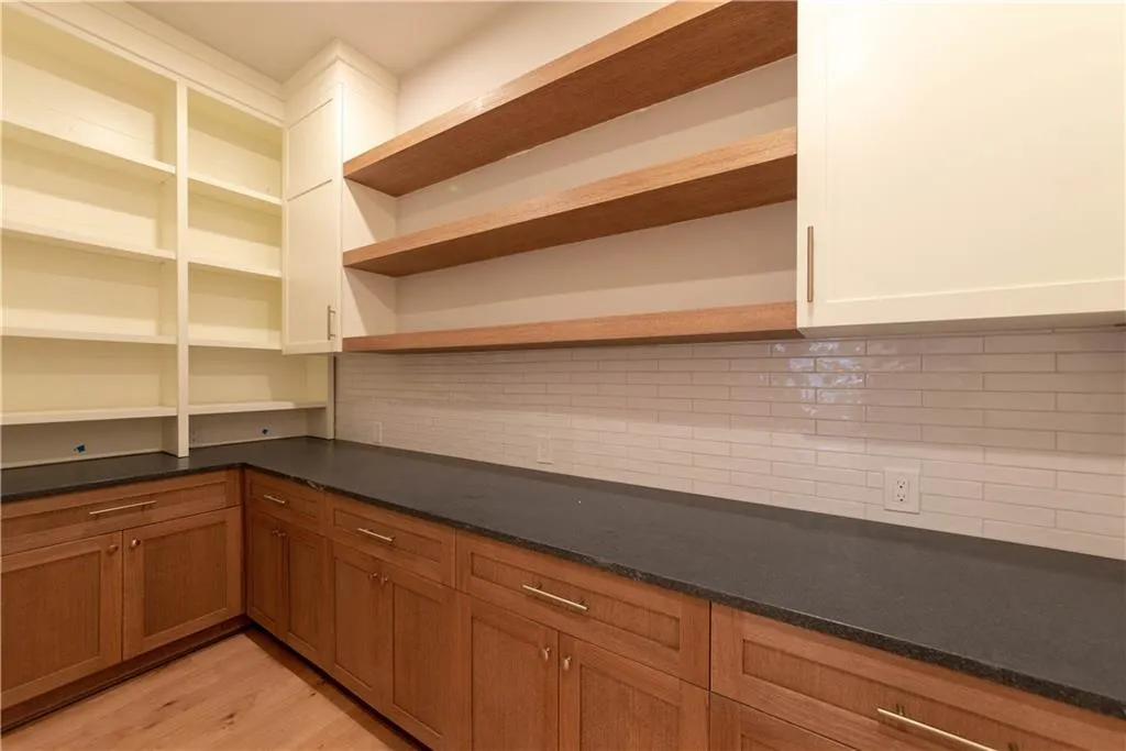 Kitchen with backsplash and light hardwood / wood-style flooring