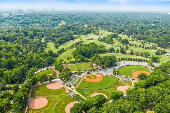 Chastain Park -Expansive green spaces with multiple baseball fields, a golf course, and a lush tree canopy