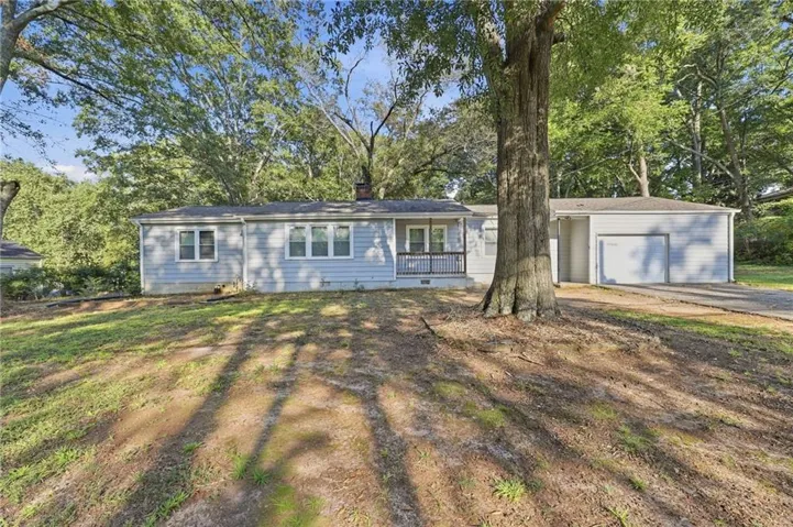 Light blue siding exterior with a single-car garage and front porch