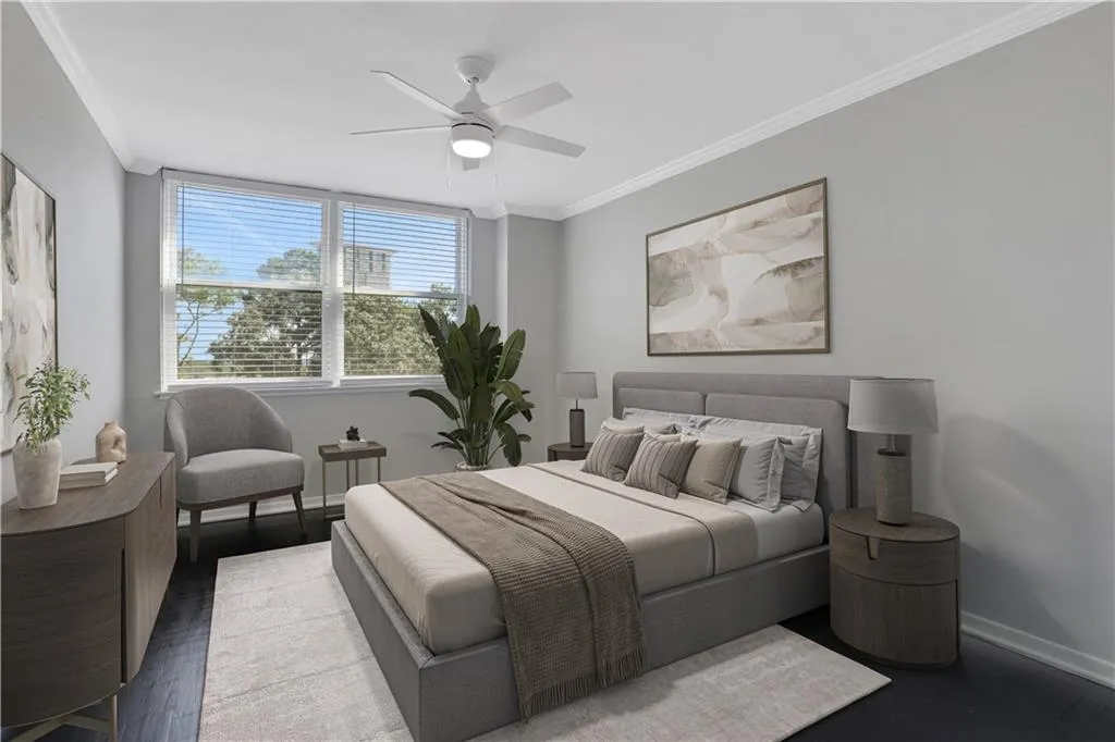 Bedroom with crown molding, a ceiling fan, and wood finished floors