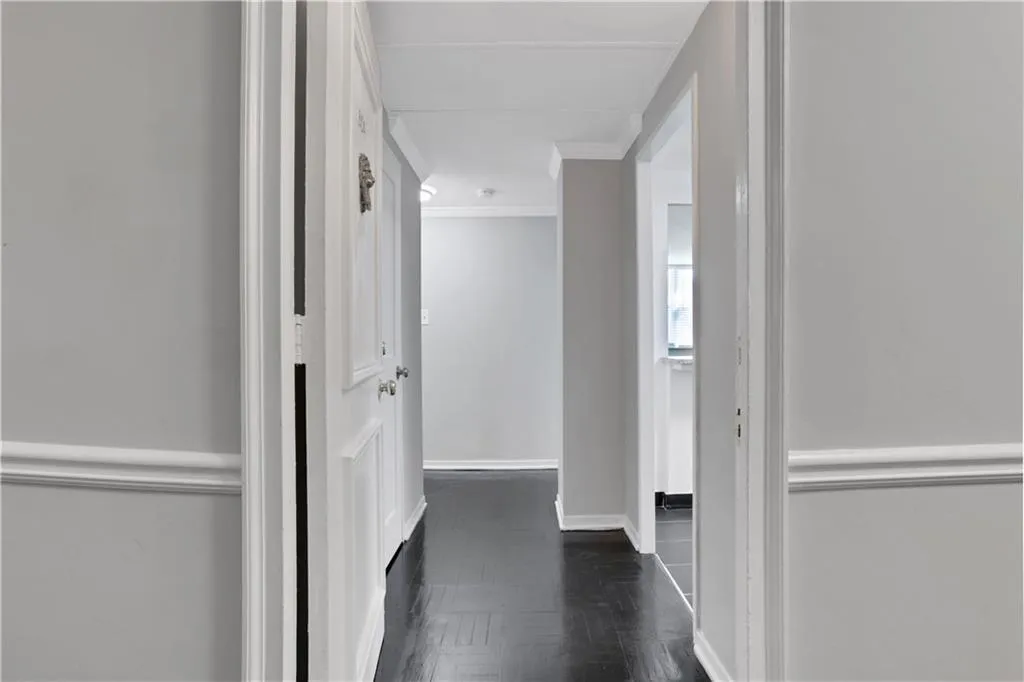Hall featuring ornamental molding and parquet flooring