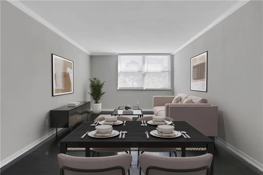 Dining area with baseboards and ornamental molding