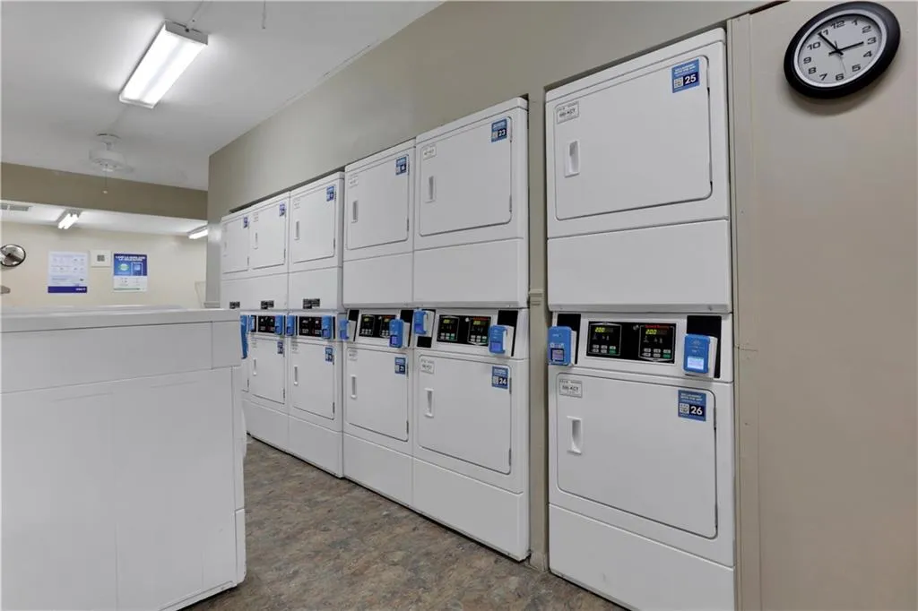 Community laundry featuring stacked washer and clothes dryer