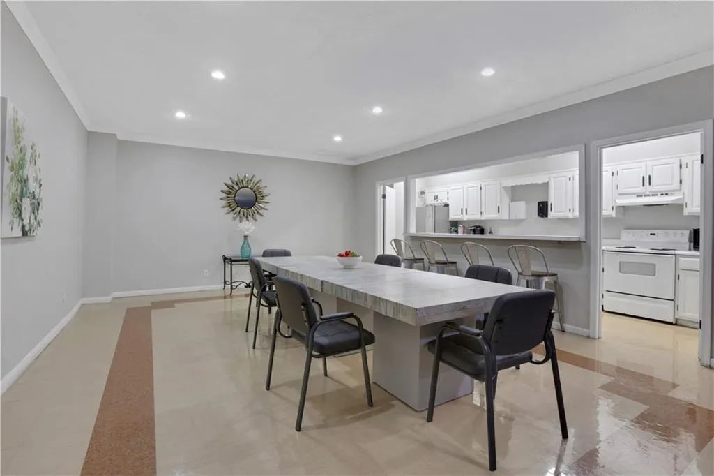 Dining area with crown molding and recessed lighting