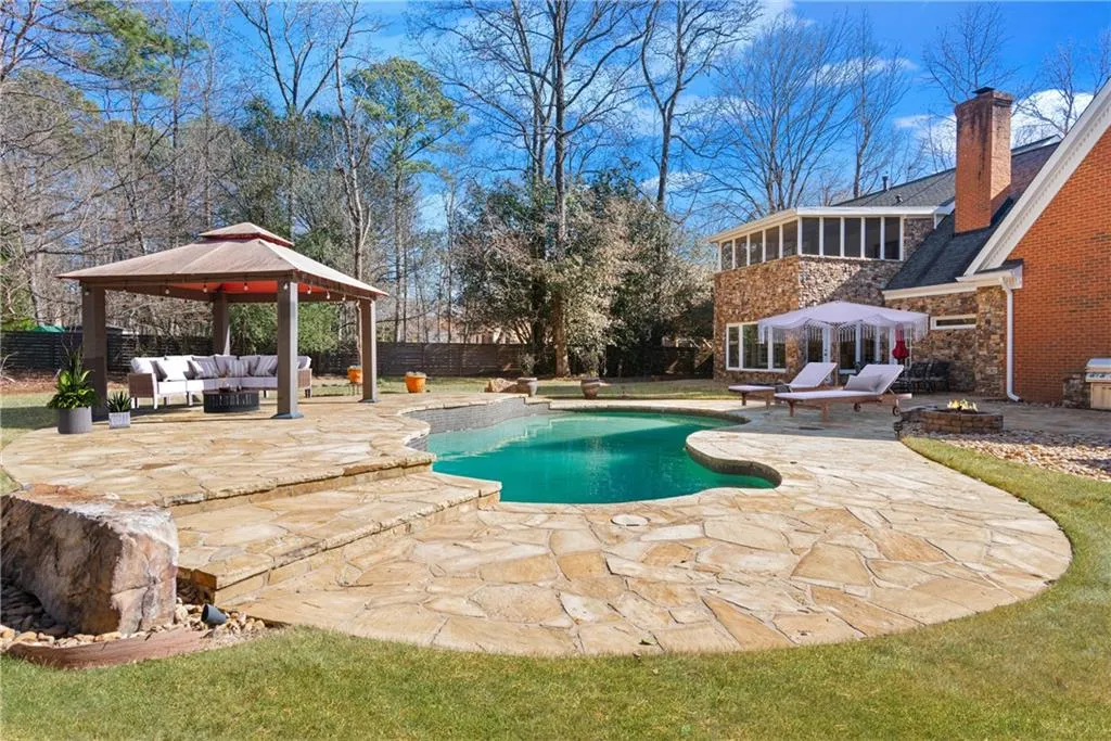 Backyard inground pool, outdoor kitchen and firepit - Virtually staged with outdoor furniture for visual reference.