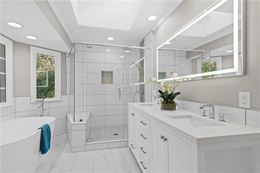 Lovely renovated primary bath with skylight.