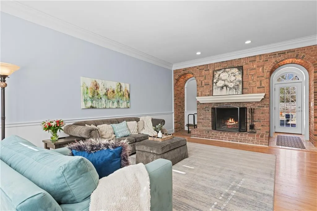 Large fireside family room with quality craftsman brick fireplace and architectural brick arches.