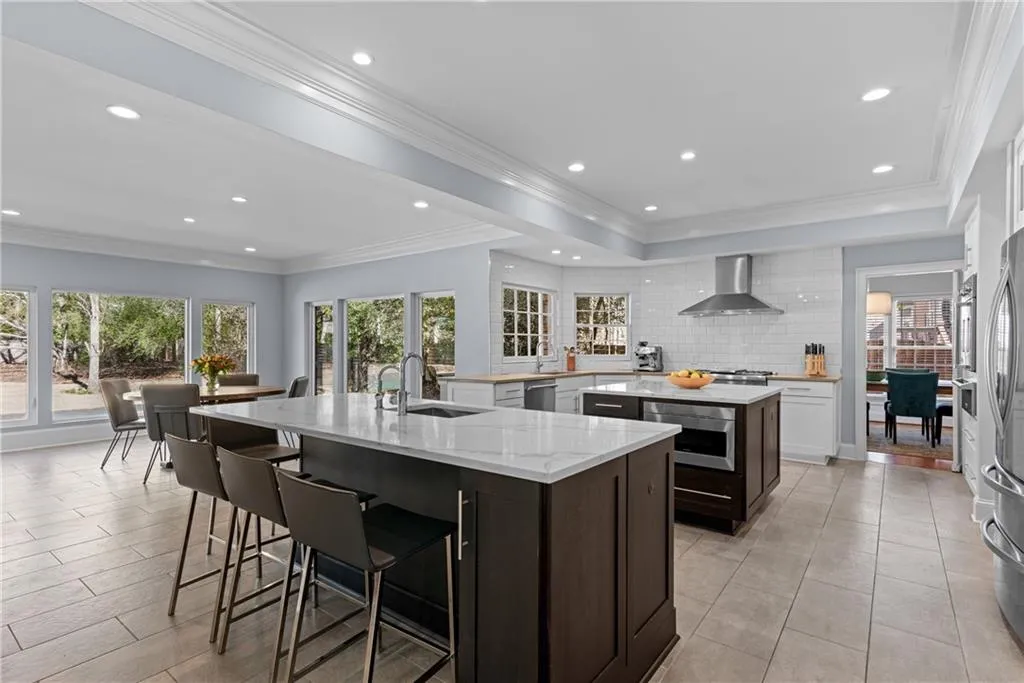 Large fantastically renovated kitchen dual islands, high end appliances and expansive views to the private backyard
