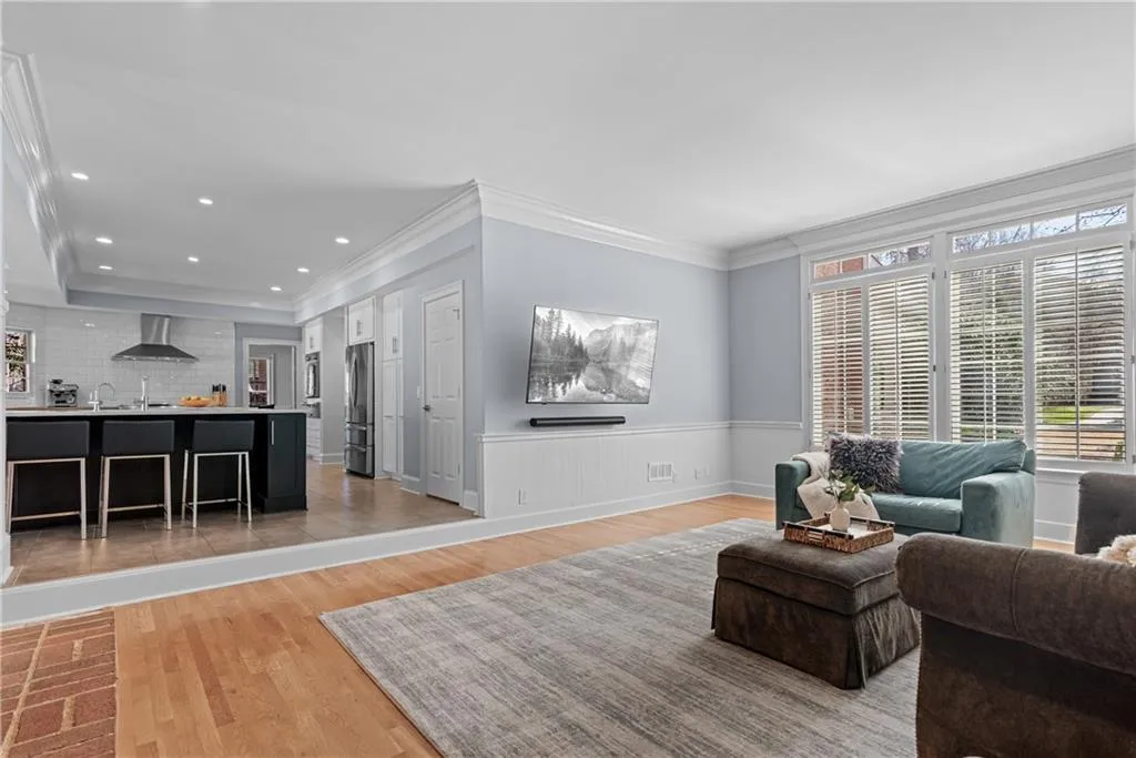 Opens to kitchen, hardwood floors, plantation shutters and high ceilings.