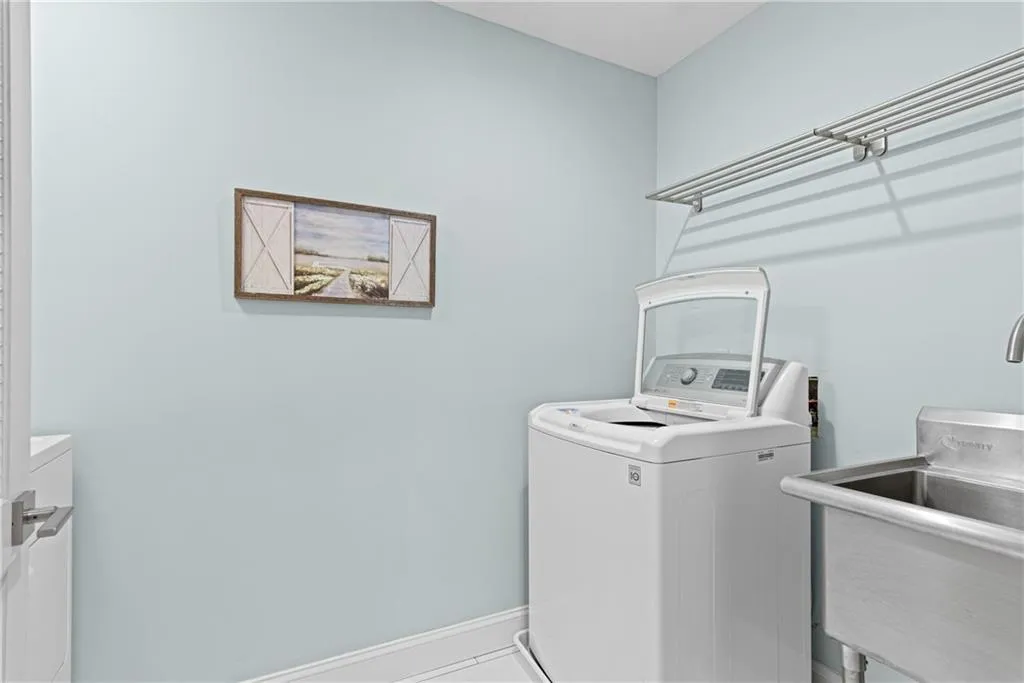 Upstairs laundry room with sink