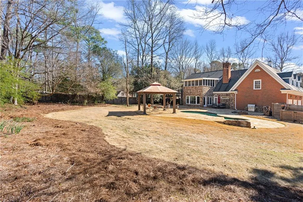 Large level landscaped fenced yard with gorgeous high wooden architectural fence for privacy,