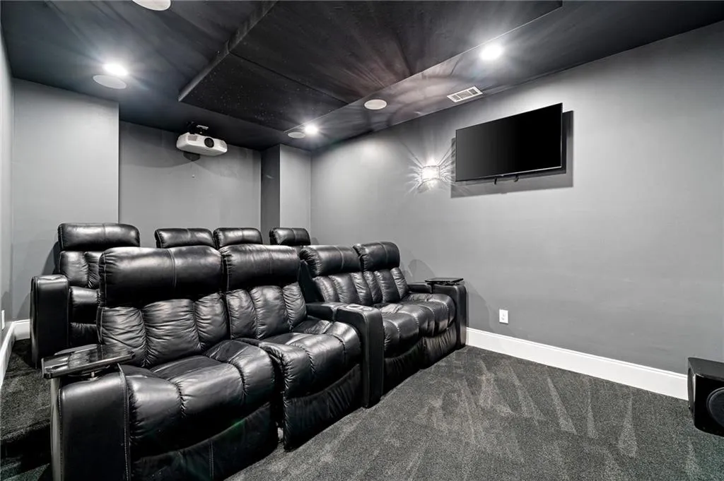 Cinema featuring carpet flooring and recessed lighting Cinema featuring carpet flooring and recessed lighting