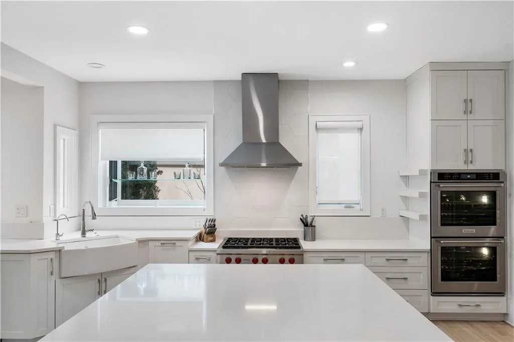 Kitchen with white cabinetry, plenty of natural light, and recessed lighting Kitchen with white cabinetry, plenty of natural light, and recessed lighting