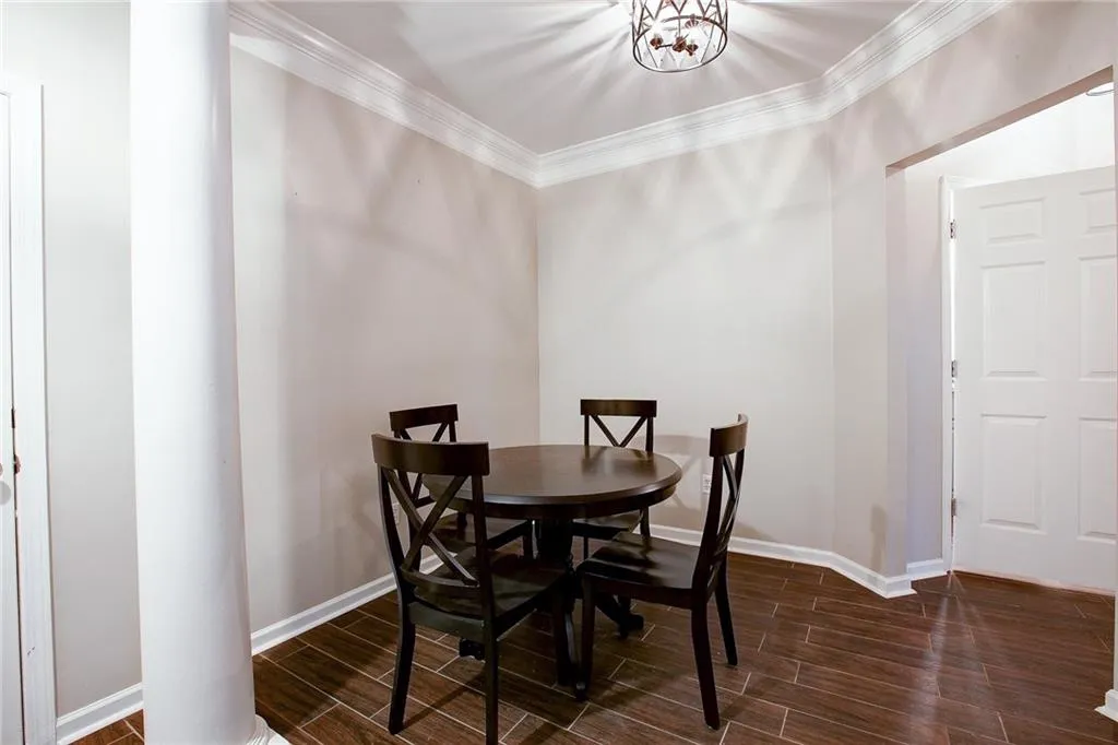 Dining area with wood tiled floors and crown molding
