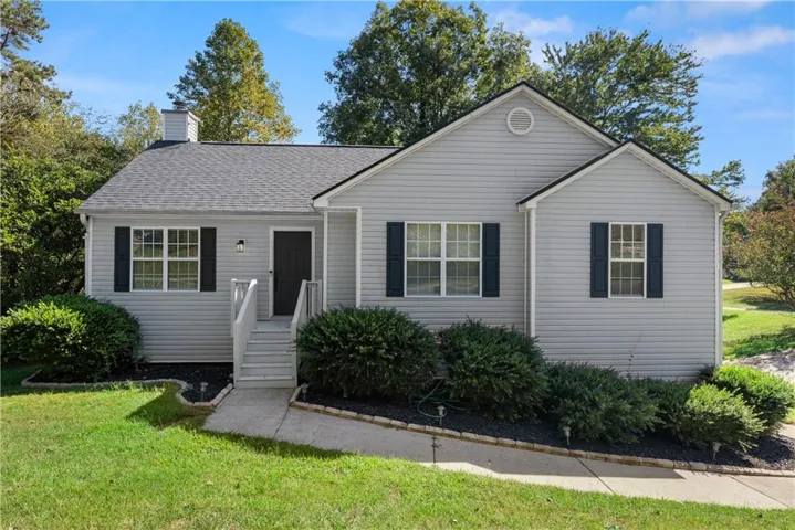 Light gray siding exterior with dark shutters