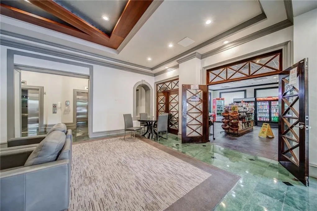 Building lobby featuring ornamental molding and recessed lighting