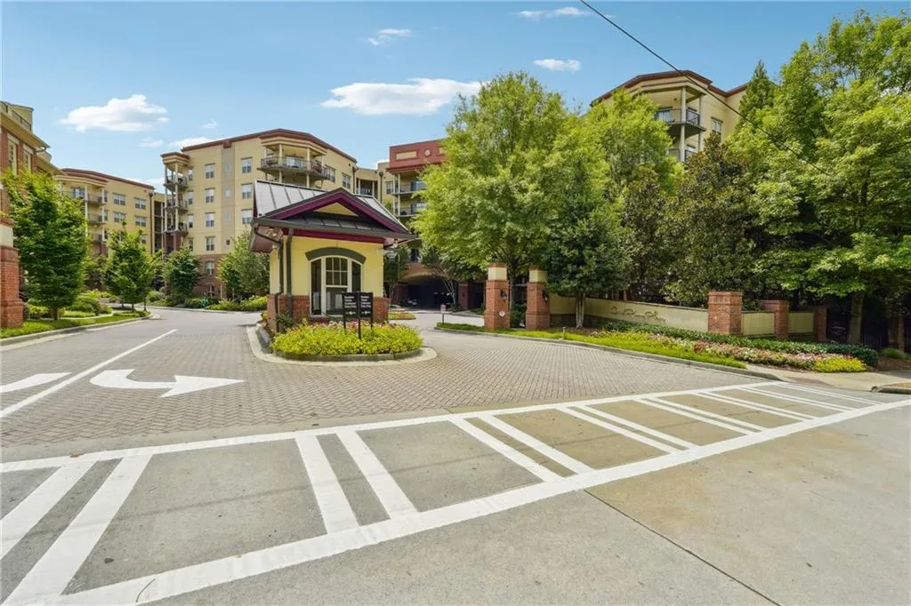 View of road with curbs and a gated entry