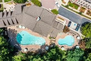 Aerial view of property and surrounding area featuring a pool