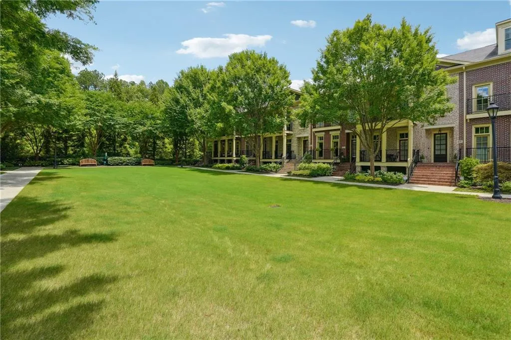 View of property's community with a lawn and a porch