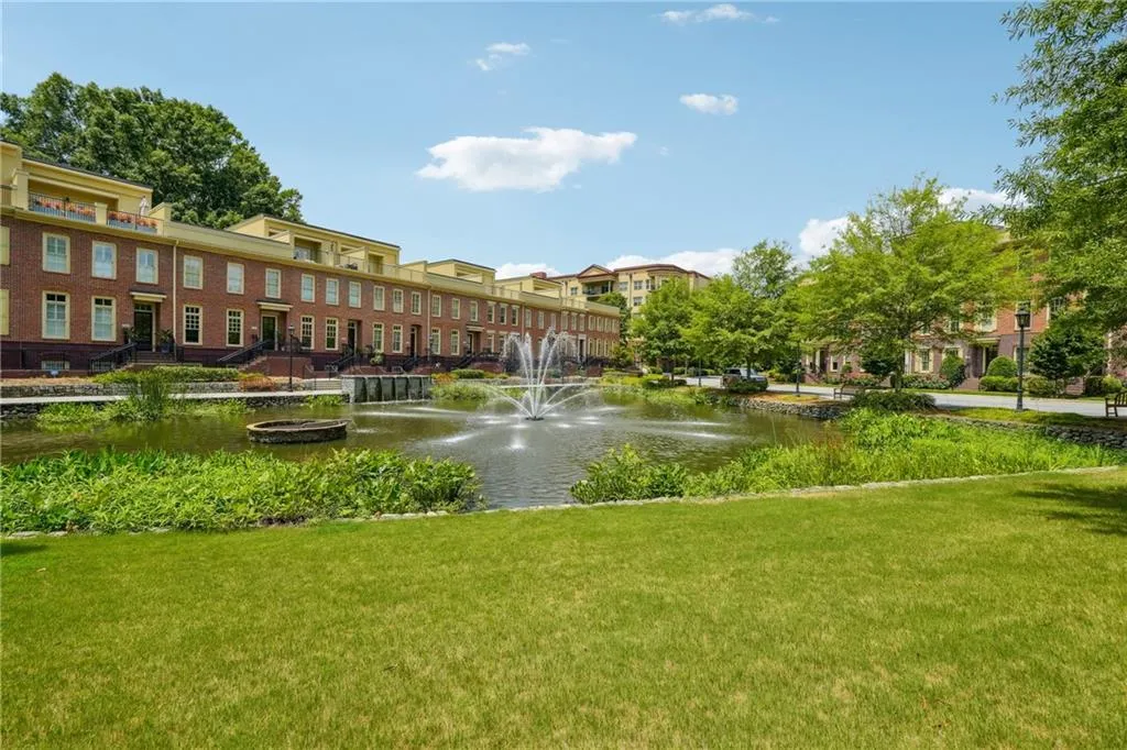 View of community featuring a water view and a lawn