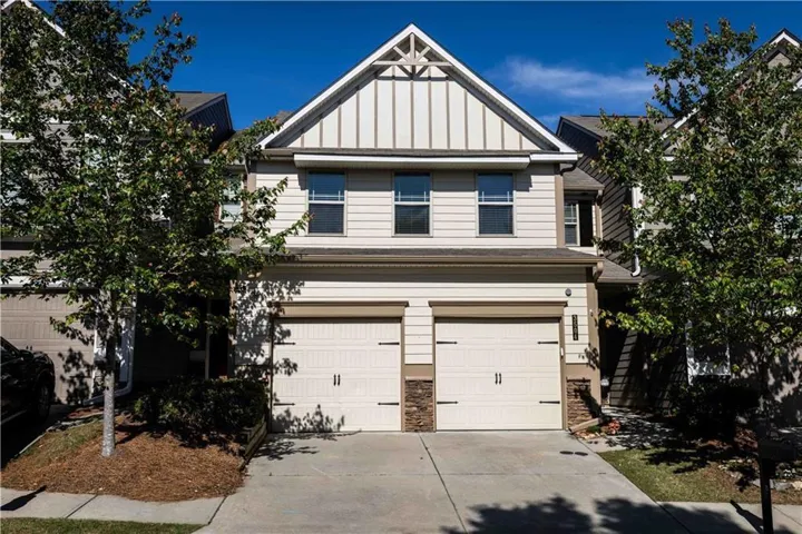 Two-story exterior with horizontal siding and board-and-batten gable accents
