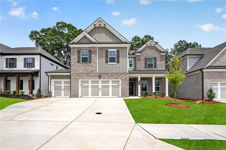 Modern two-story residence featuring a brick and siding exterior, a prominent front entry with columns, multiple gables, and an attached three-car garage